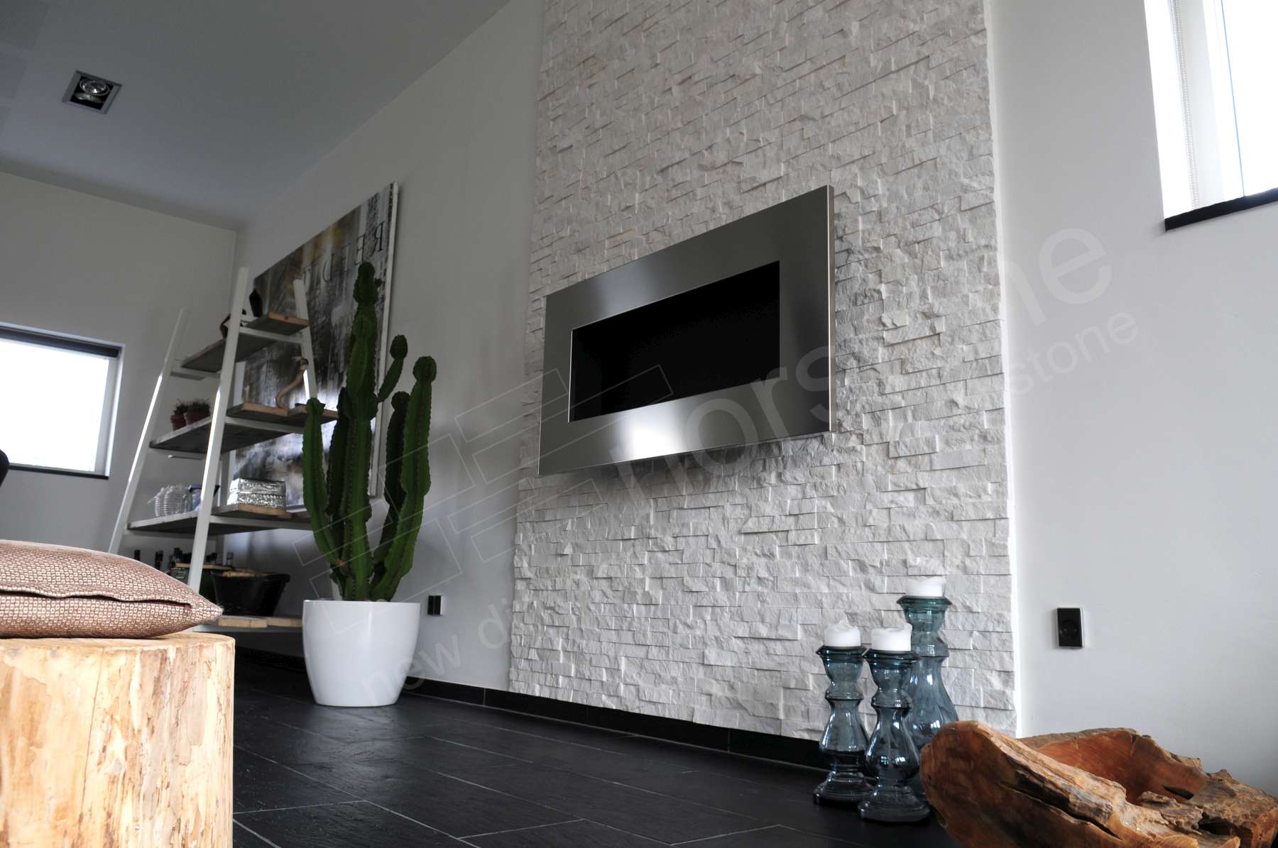Norstone White Rock Panels on thin fireplace in Denmark with a large chest level staineless steel fireplace